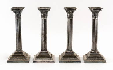 FOUR GORHAM SILVER PLATED CANDLESTICKS Formed as Corinthian columns. Removable bobèches. Monogrammed bases. Heights 10.25".