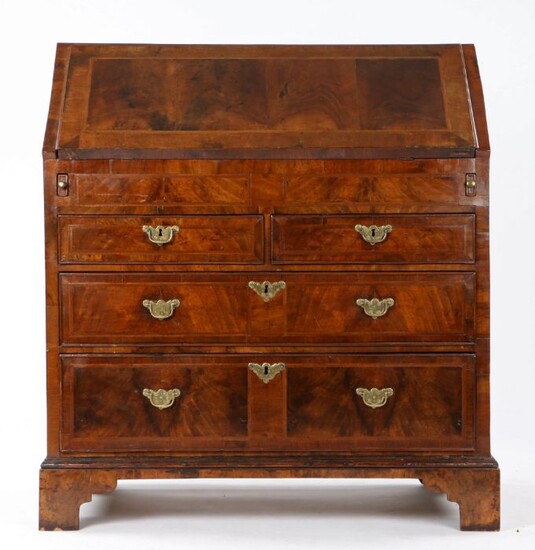 George I walnut bureau, early 18th Century, the top with cross and feather banding, above the hinged