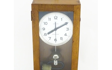 Lepaute : An early 20thC oak cased electric clock. The white...