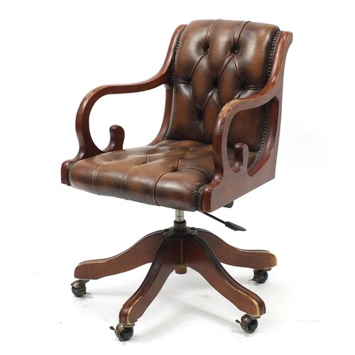 Mahogany framed captains chair with brown leather button bac...