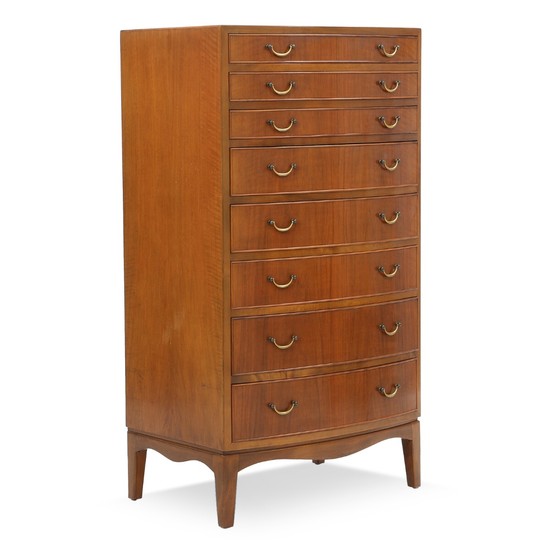 Ole Wanscher: Chest of drawers of nutwood. Curved front with eight profiled drawers with brass handles.