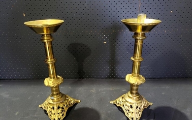 Pair of Ecclesiastical Brass Candlesticks, the turned shaft with foliate knop, the tri-form base pierced with grapevines (repair to...