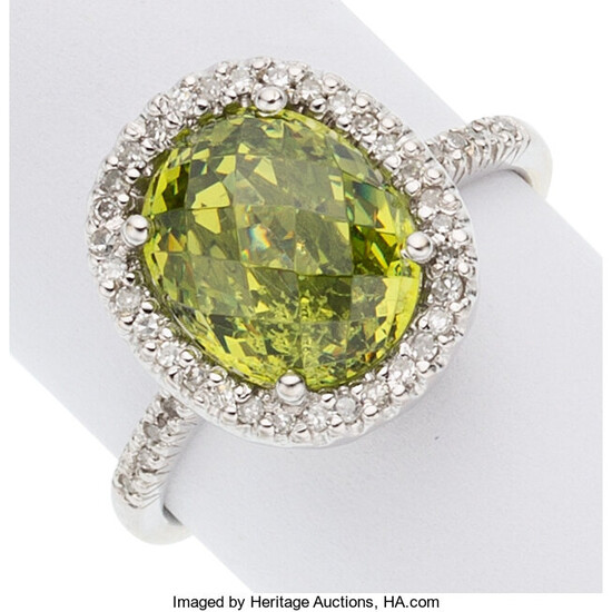 Peridot, Diamond, White Gold Ring The ring features an...