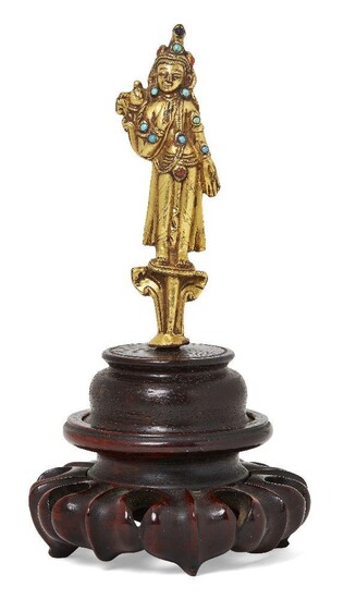 Property of a Gentleman (lots 36-85) A Tibetan gilt-bronze 'jewelled' figure of Maitreya, 17th century, cast standing wearing a long shawl, his left hand placed in the gesture of supreme generosity, his right hand held to his chest clutching a...