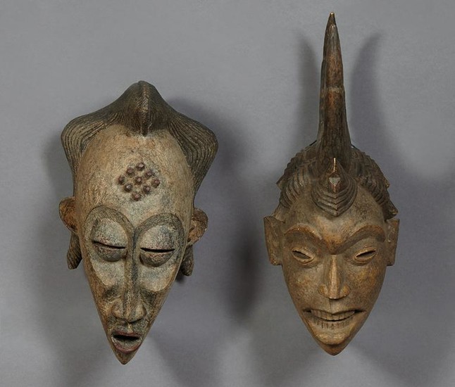 Two African Carved Wood Masks, 20th c., one of a woman