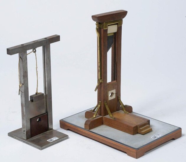 Two masterpieces depicting two "Guillotines", one in wood, copper, brass and ivory resting on a rectangular base and the second in chrome-plated metal. Period: late 19th and early 20th century. H.(out of the base):21,3 and 23,8cm.