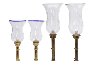 Two pairs of 19th century brass hurricanes with glass shades. H. 39...