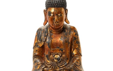 Vietnamese Buddha of carved gilt and black lacquered wood sitting in meditative position. 20th century. H. 49 cm.