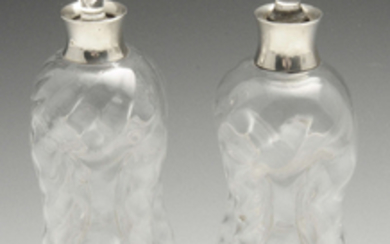 A matched pair of Edwardian silver mounted glug-glug decanters.
