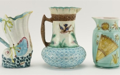 THREE MAJOLICA PITCHERS 1) Decorated with birds and faux caning. Incised "A" on underside. Height 9.25". 2) Decorated with Japanese...