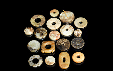 A group of eighteen archaistic jade bi discs, sword fittings and carvings