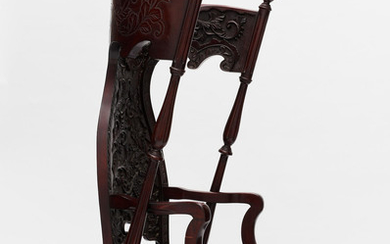 An unusual and large hardwood high-back chair