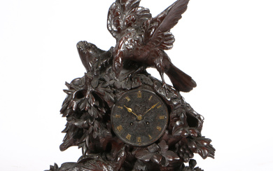 A 19TH CENTURY BLACK FOREST LARGE NATURALISTICALLY CARVED MANTEL CLOCK.