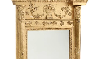 A 19th century Empire giltwood mirror, richly decorated with dolphins, ornamentation and...