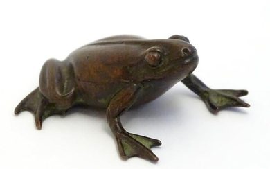 A 20thC cast model of a seated frog. Approx. 1 3/4"