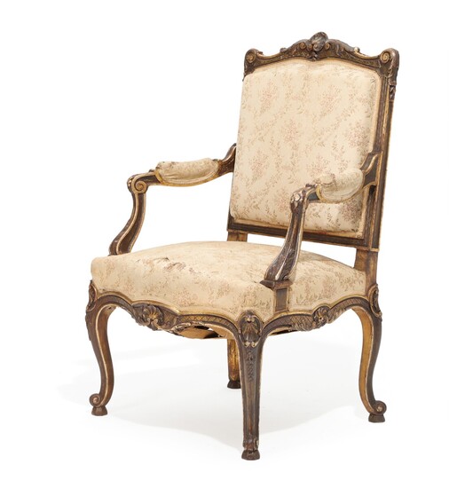A French 19th century gilt and dark patinated wood Napoleon III armchair, carved with flowers and foliage.