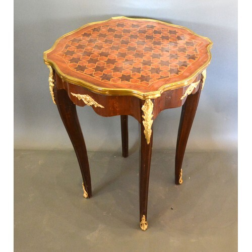A French inlaid and gilt metal mounted lamp table, the star ...