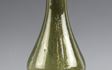 A George III green glass wine bottle, late 18th century, of ...