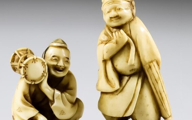 A Japanese Carved Ivory Netsuke of a Figure Holding...