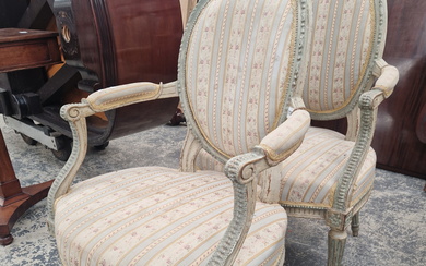 A PAIR OF GREY PAINTED FAUTEUILS, THE OVAL BACKS UPHOLSTERED WITHIN BEADED FRAMES, THE TAPERING