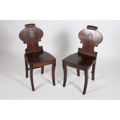 A PAIR OF REGENCY MAHOGANY HALL CHAIRS each with a shaped cr...