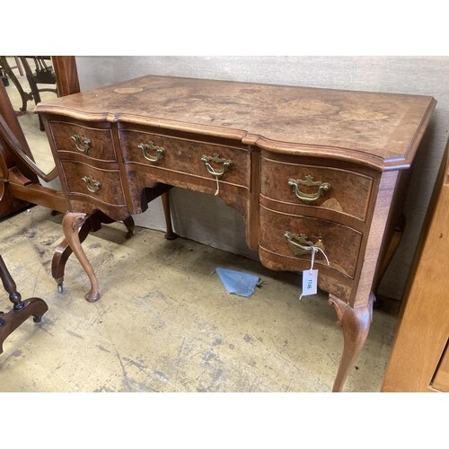 A Queen Anne revival mahogany and walnut breakfront serpenti...