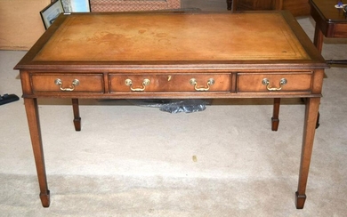 A REPRODUCTION THREE DRAWER LEATHER INSET DESK. 136 cm