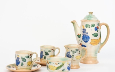 A Royal Doulton 'Brangwyn Ware' Harvest coffee set for two designed by Frank Brangwyn, decorated with a band of grape, fruit and a sheaf of corn in colours on a pale green and cream ground, comprising coffee pot and cover, milk-jug and sugar basin...
