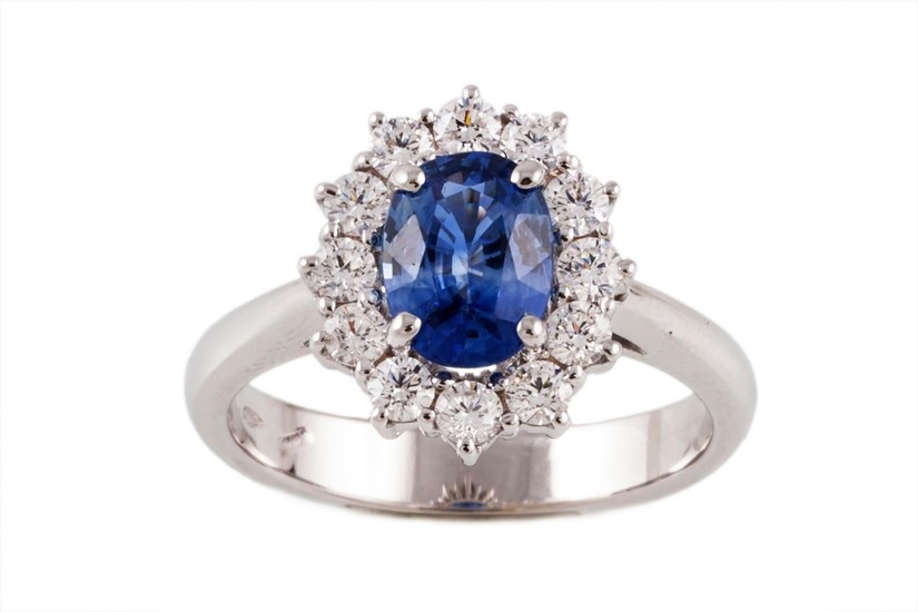 A SAPPHIRE AND DIAMOND OVAL CLUSTER RING, one oval cut sapph...