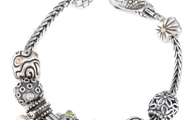 A SILVER CHARM BRACELET; LAA American silver foxtail bracelet attached with assorted Pandora silver charms, length 18cm.