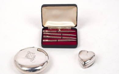 A cased set of four bridge pencils, stamped sterling silver, each with engine turned stem to squared terminal decorated with suit motif, together with a rounded squeeze action snuff box, Chester, 1911, Colen Hewer Cheshire, engraved monogram to...