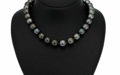SOLD. A graduated Tahiti pearl necklace set with numerous cultured Tahiti pearls, clasp of silver...