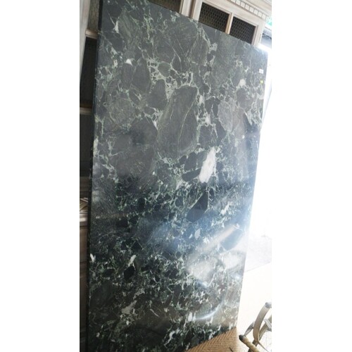 A green marble top dining table, on faux carved stone suppor...