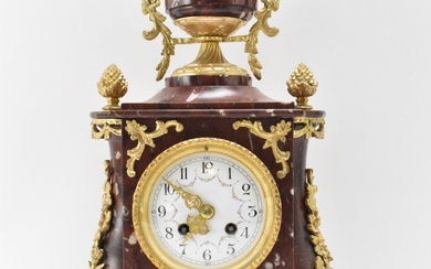 A late 19th century French red marble mantle clock,...