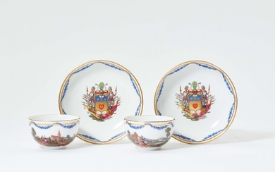 A pair of Berlin KPM porcelain cups and saucers with landscape decor