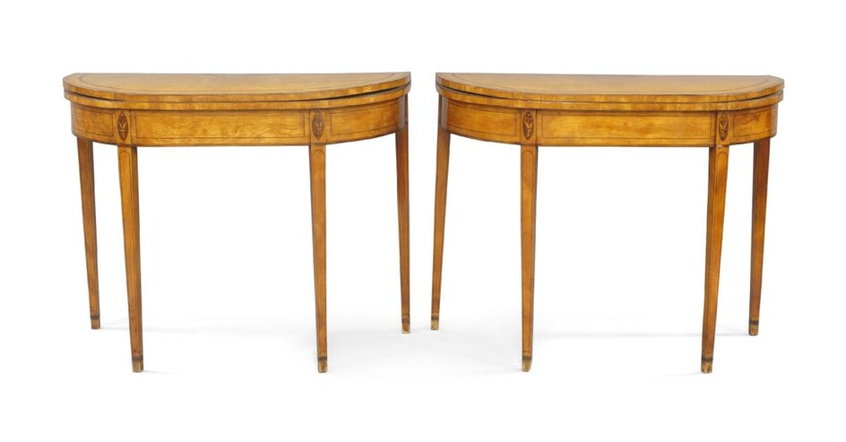 A pair of George III satinwood D shaped card tables, late 18th century, the tops crossbanded and strung with shell inlay on tapered square legs, 73cm high, 91cm wide, 40cm deep