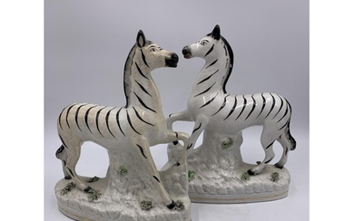 A pair of Staffordshire pottery flatback zebra figurines - a...