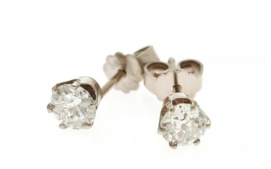 A pair of diamond ear studs respectively set with a brilliant-cut diamond and an old-cut diamond, each mounted in 14k white gold. (2)