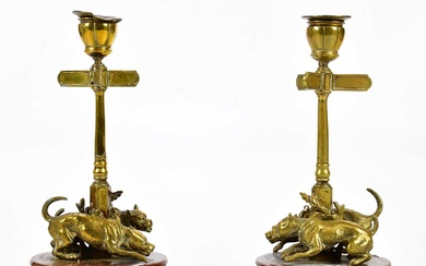 A pair of late 19th century bronze candleholders, modelled as...