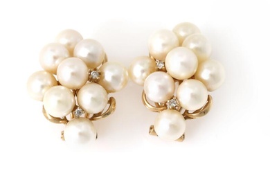 A pair of pearl and diamond ear clips each set with nine...