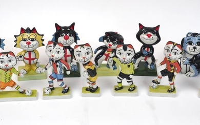 A quantity of Lorna Bailey pottery cats, 20th century and later, modelled with football theme, with four England black and blue cats, a yellow England cat, four further footballers, two referees and one cat holding ball, signatures to bases...