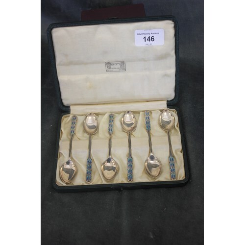 A set of six George V silver gilt and enamelled coffee spoon...