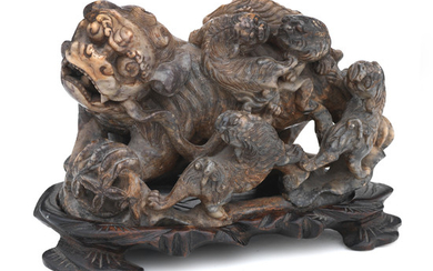 A soapstone model of a Buddhist lion dog and cubs on stand