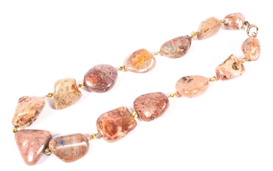 A strand of free cut Mexican fire opal beads in matrix rock.