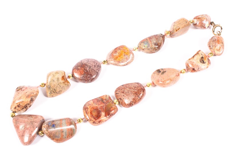 A strand of free cut Mexican fire opal beads in matrix rock.
