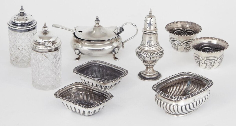 A three-piece silver cruet set, London, c.1901, Josiah Williams & Co, the two circular salts and baluster pepper repousse decorated with floral and scroll motifs, together with a blue glass-lined silver mustard, Birmingham, c.1926, Walker&Hall; a...