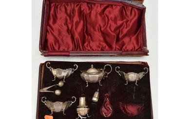 AN INCOMPLETE CASED SILVER CRUET SET, including three salts,...