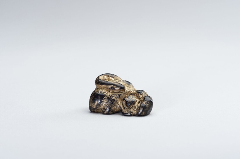 AN UNUSUAL LACQUERED DARK WOOD NETSUKE OF A SNAKE AND FROG