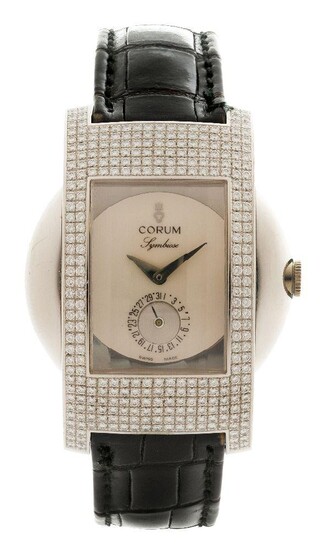An 18ct white gold 'Symbiose' diamond wristwatch, by Corum the rectangular dial with subsidiary dial within a frame pave-set with brilliant-cut diamonds to a leather strap with Corum buckle stamped 750 with Swiss assay marks, automatic movement...