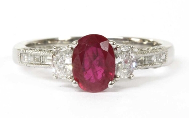 An 18ct white gold ruby and diamond three stone ring